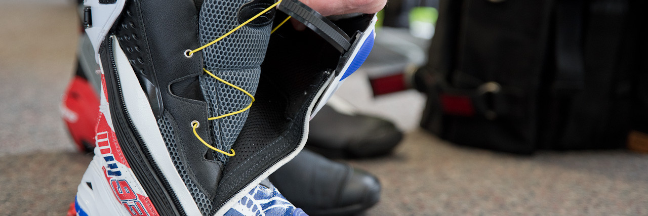 Man zipping up boots