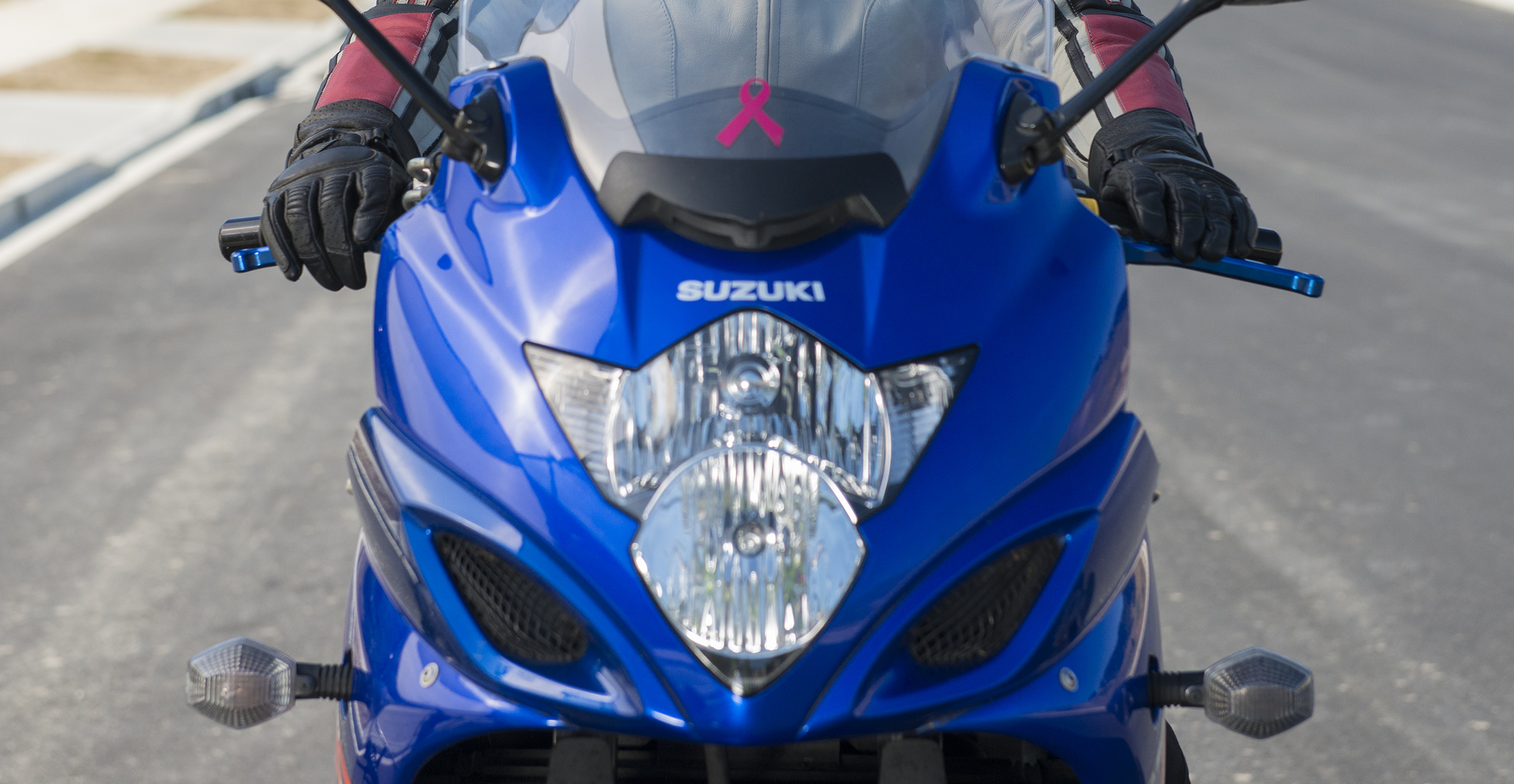 Close up of front of bike with motorcyclist riding