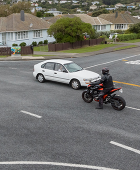 Bike waiting to turn right with oncoming traffic